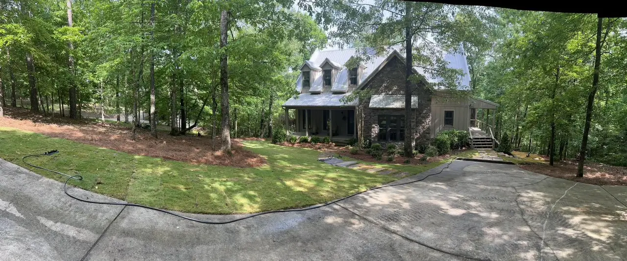 A cabin seen across new lawn from the drive