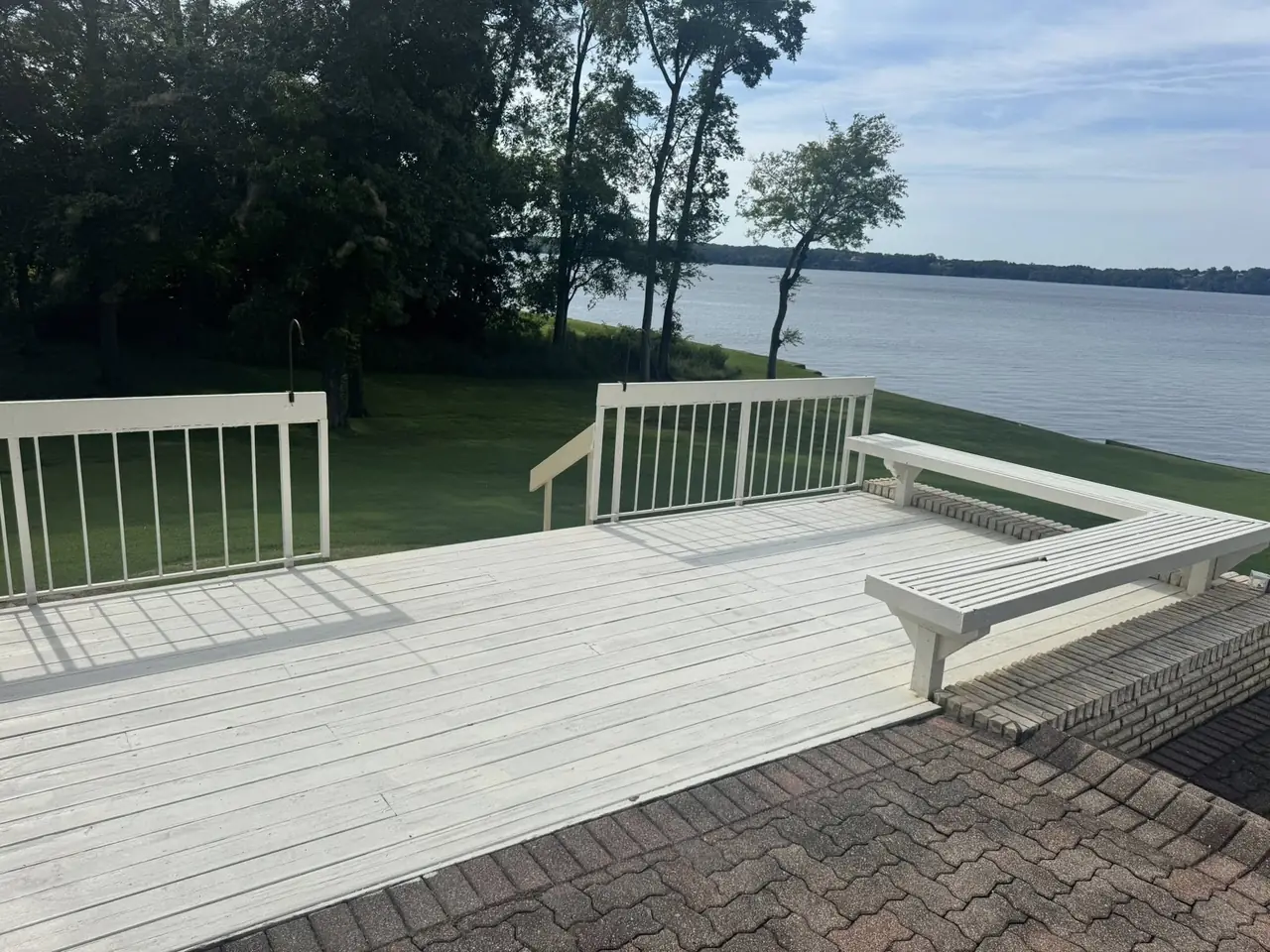 A deck with built-in benches looking out over the lake