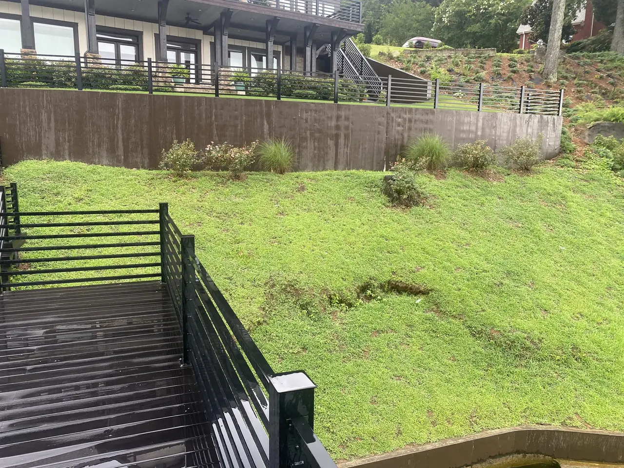 A new lawn on a lakeside slope above the dock