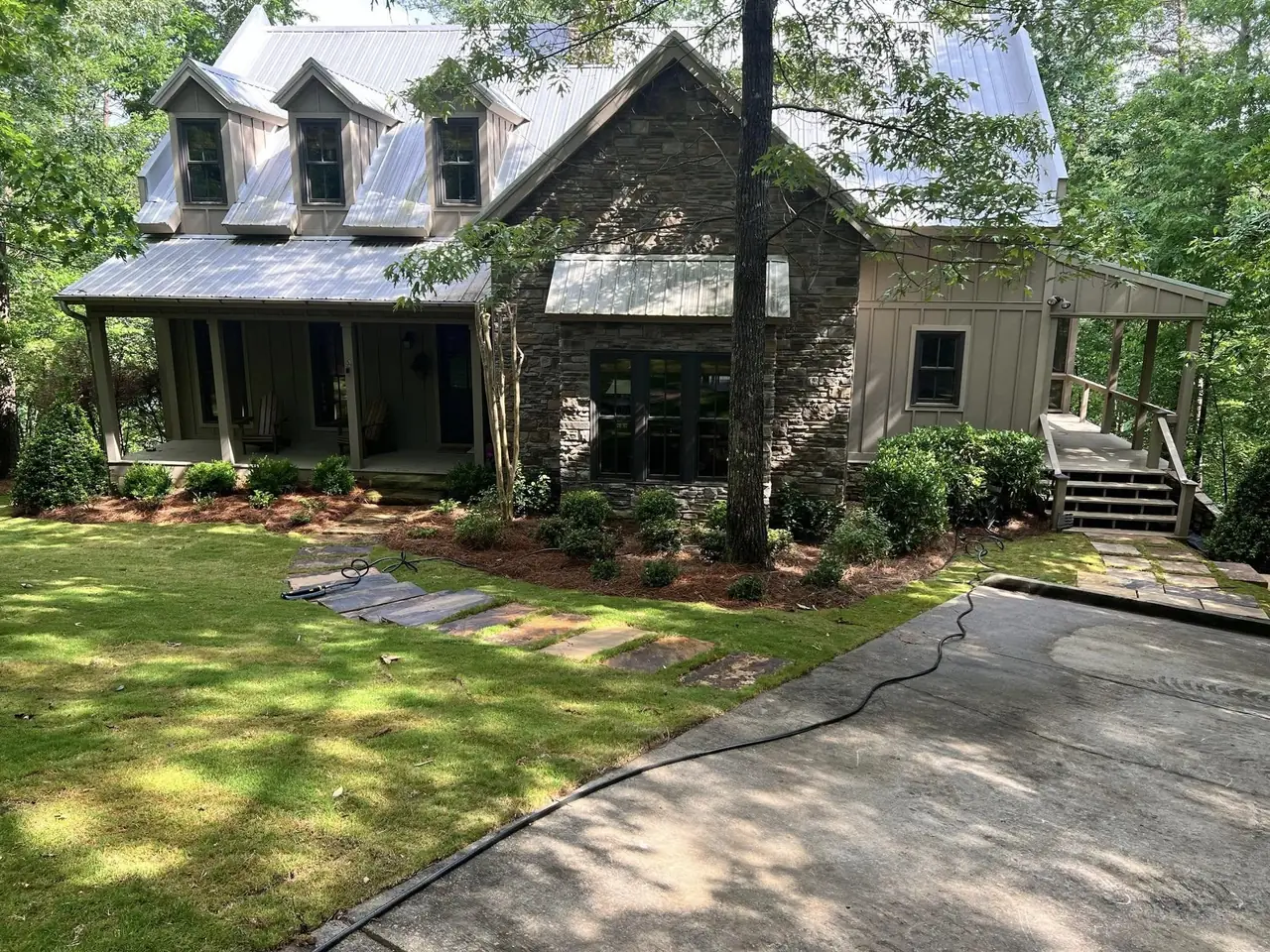 New sod and beds around a stone-and-board cabin