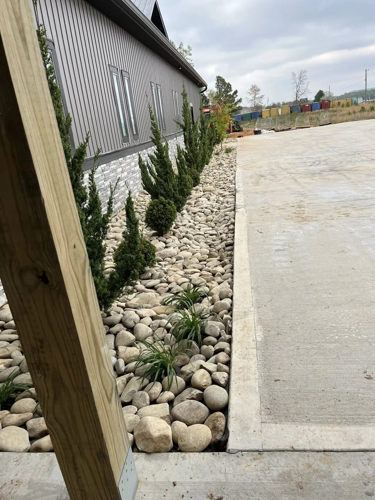 A river-rock drainage strip along a building