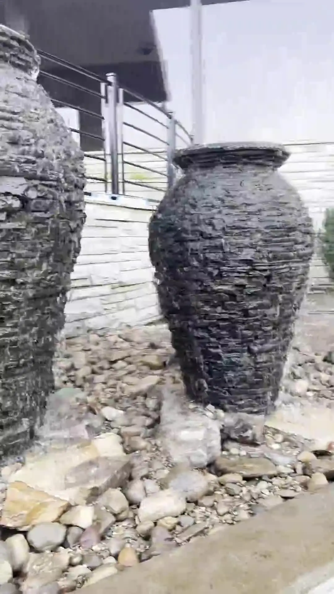 Tall dark urn fountains beside a stair
