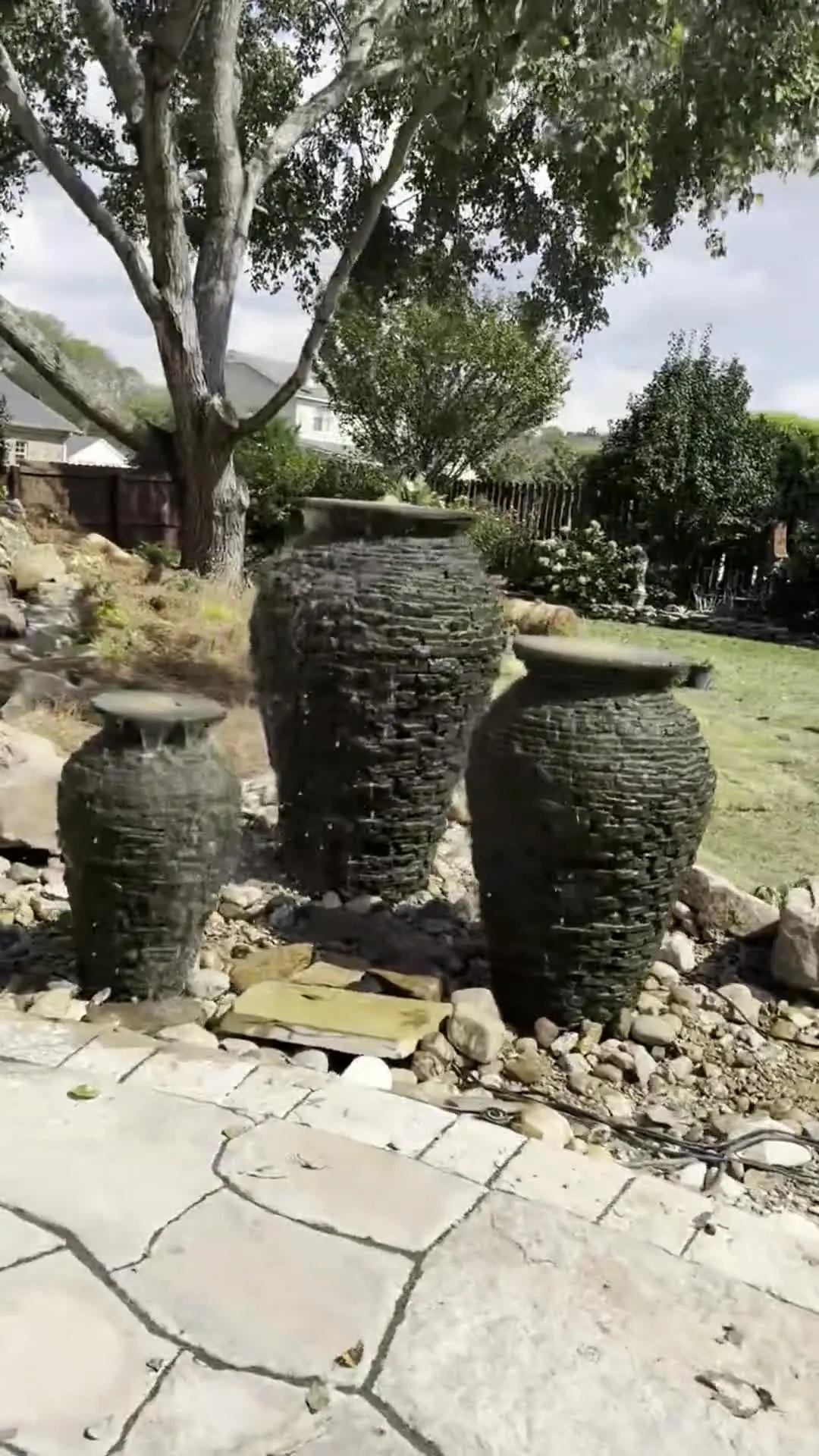 Three urn fountains on a stone terrace