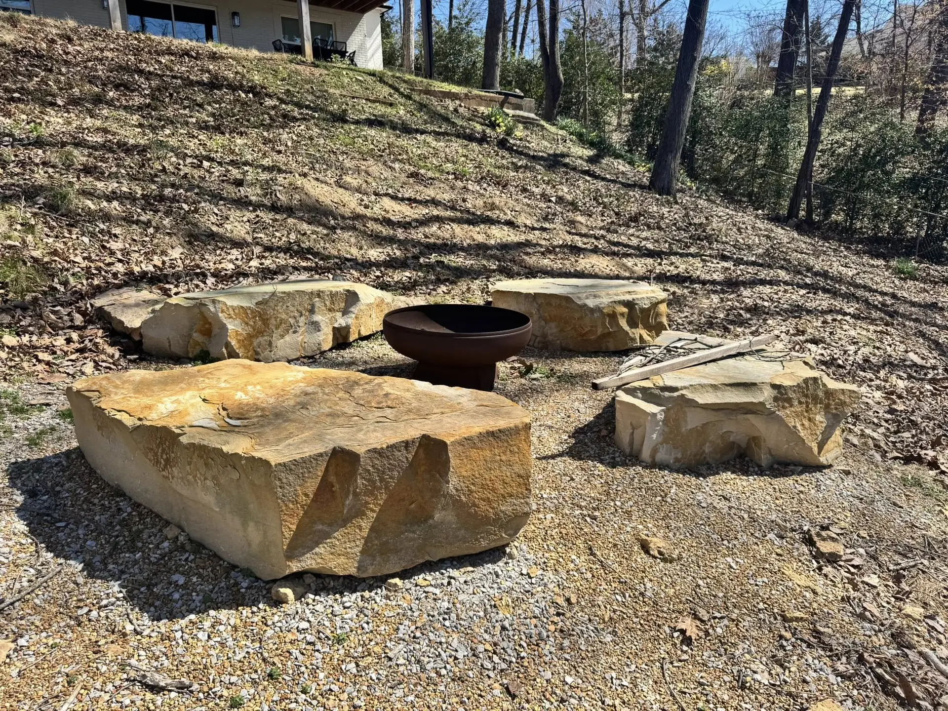 Sandstone boulder seats set around a steel fire pit