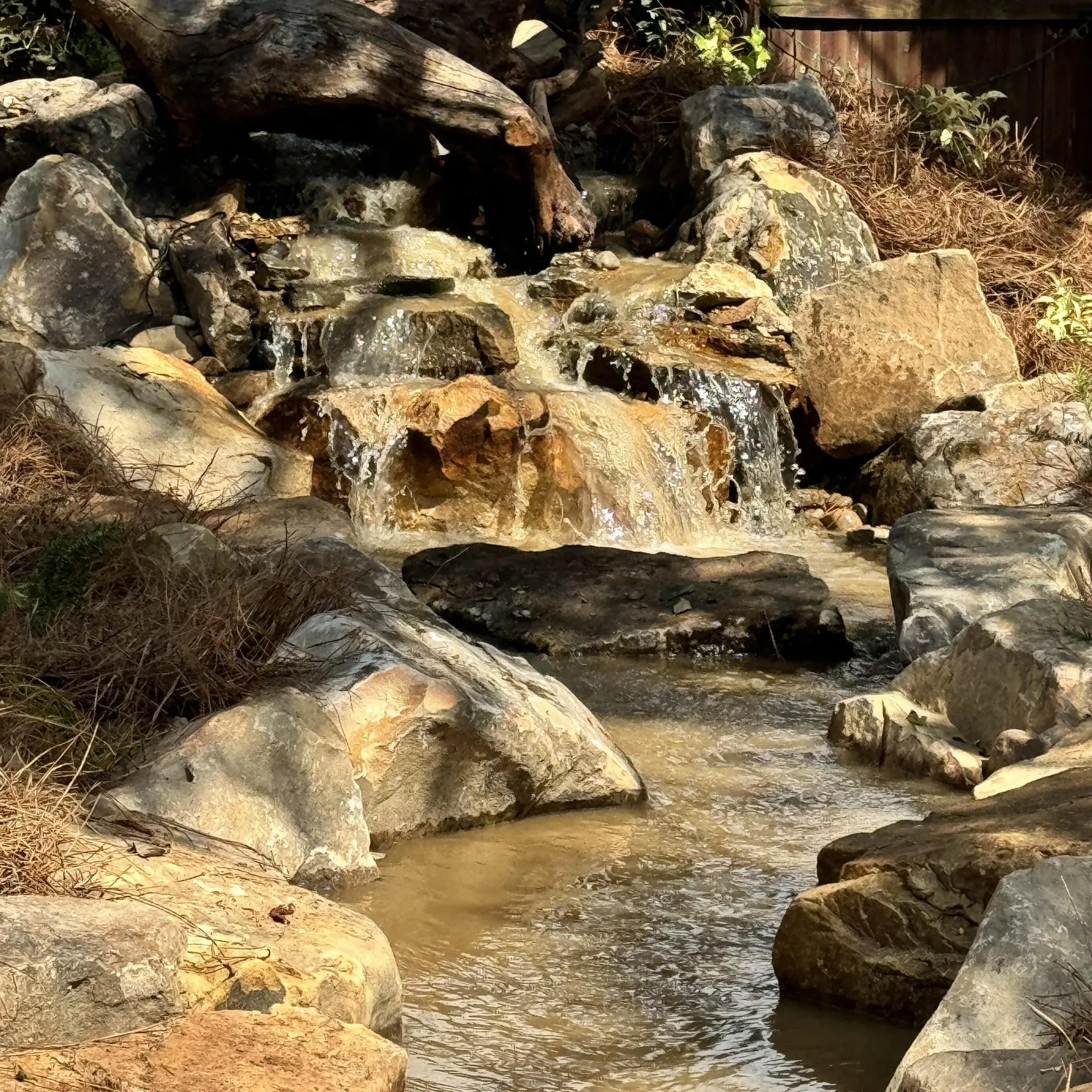 Boulders and a clear pool where a stream drops