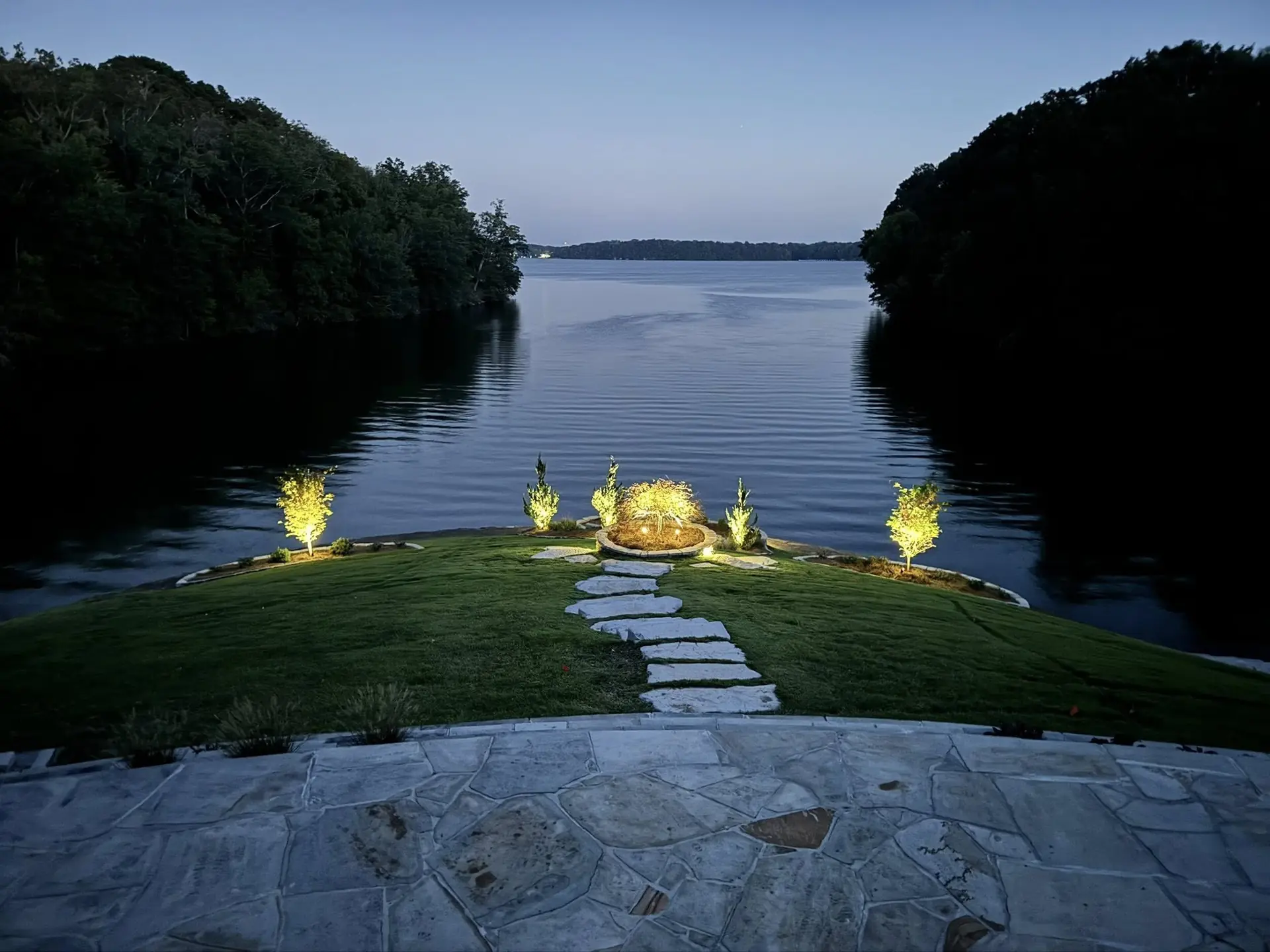 Path lights along a stepping-stone walk to the water at dusk